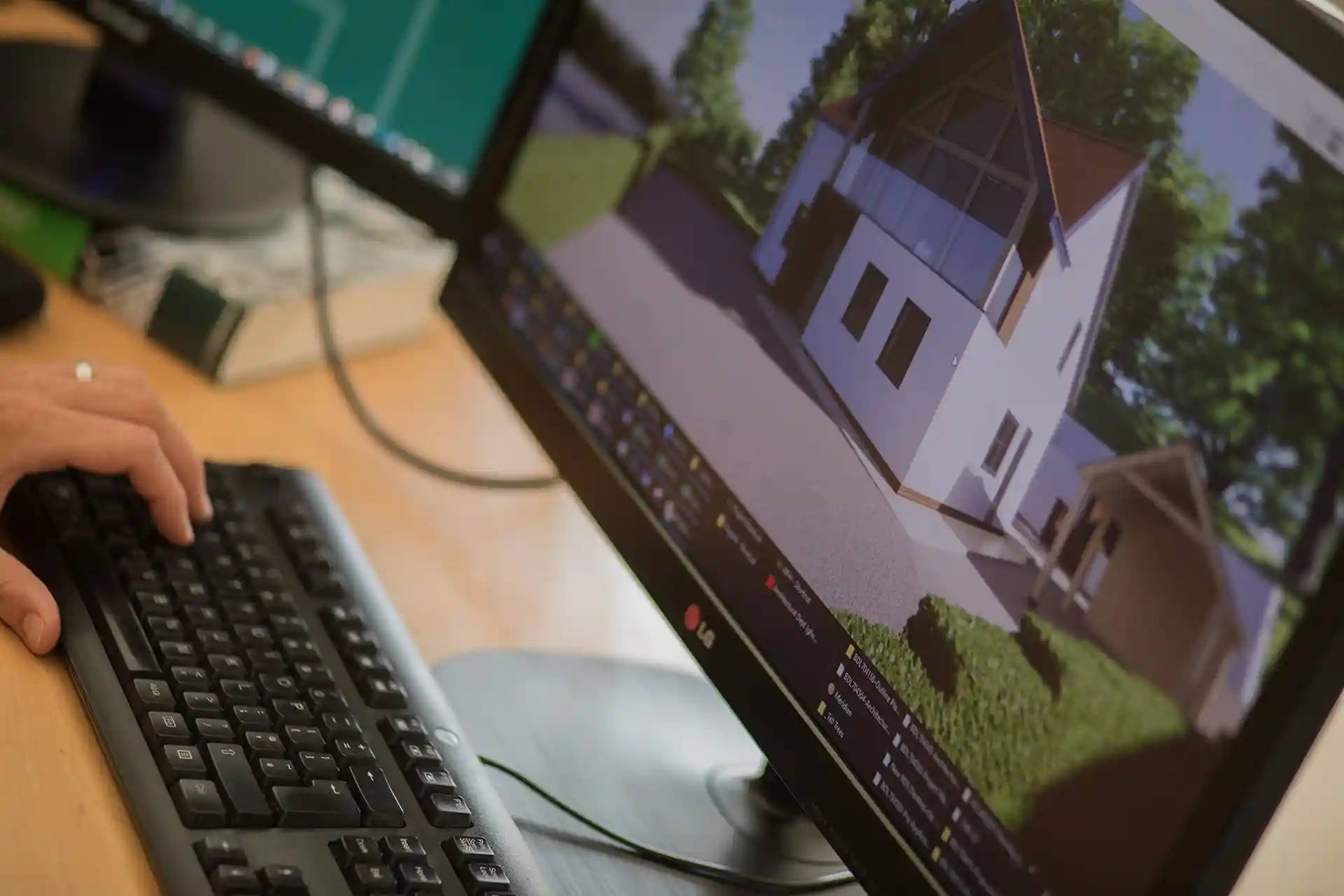Monitor screen showing CGI of a residential property