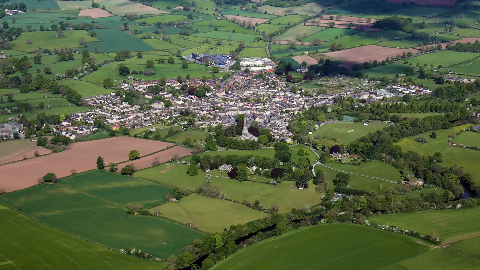 Aerial view of village surrounded by fields